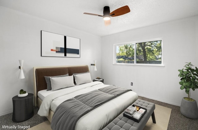 carpeted bedroom with ceiling fan, baseboards, and a textured ceiling