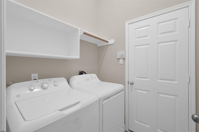 clothes washing area featuring laundry area and separate washer and dryer