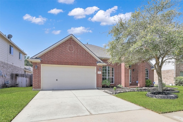 view of front of home with a front yard, fence, driveway, an attached garage, and brick siding