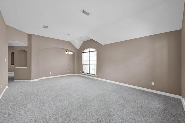 spare room featuring visible vents, an inviting chandelier, baseboards, and lofted ceiling