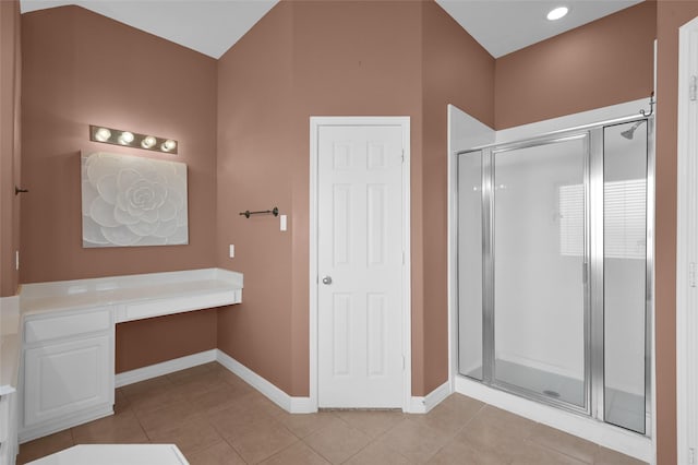 bathroom with tile patterned floors, a stall shower, and baseboards