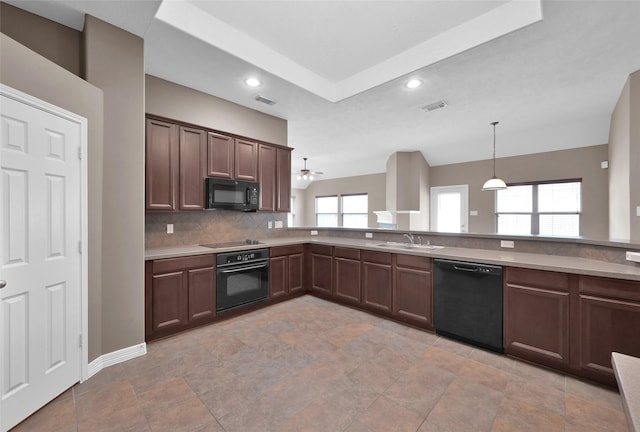 kitchen featuring visible vents, black appliances, decorative backsplash, and a sink