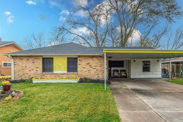 ranch-style house featuring concrete driveway, roof with shingles, a front lawn, a carport, and brick siding