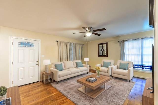 living area featuring a ceiling fan and wood finished floors