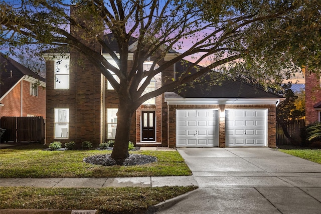 view of front of home with brick siding, an attached garage, concrete driveway, and fence