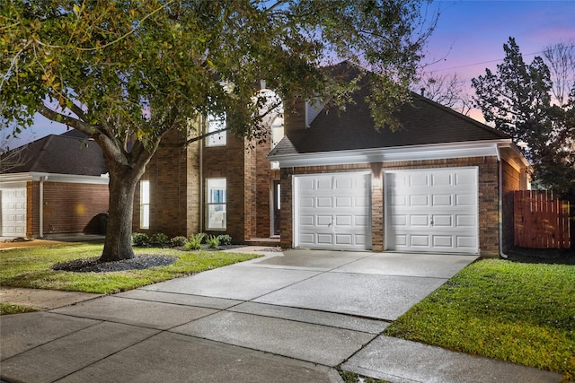 view of front of home featuring an attached garage, brick siding, and driveway