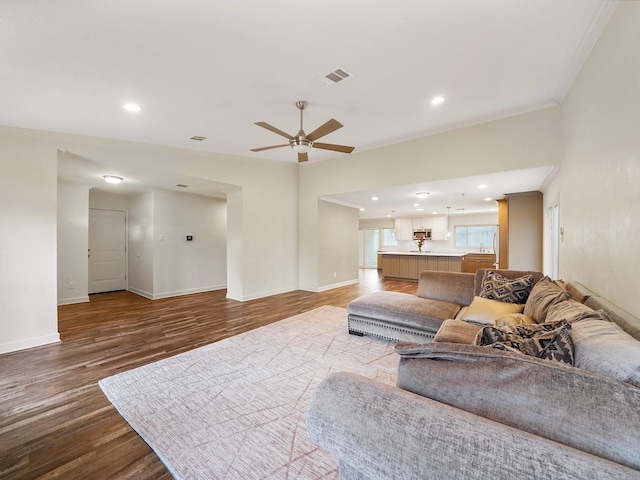 living area featuring baseboards, visible vents, ceiling fan, wood finished floors, and recessed lighting