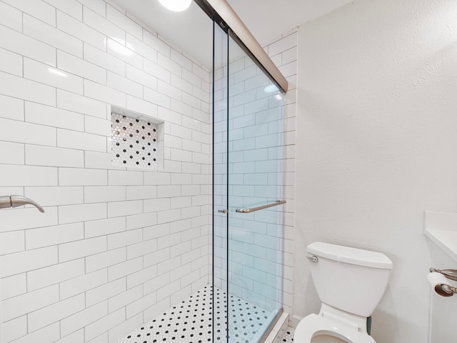 full bath with a stall shower and toilet