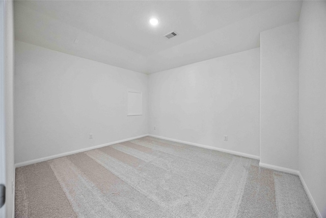 unfurnished room featuring carpet, visible vents, and baseboards