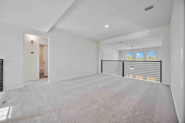 carpeted empty room featuring recessed lighting, visible vents, and baseboards