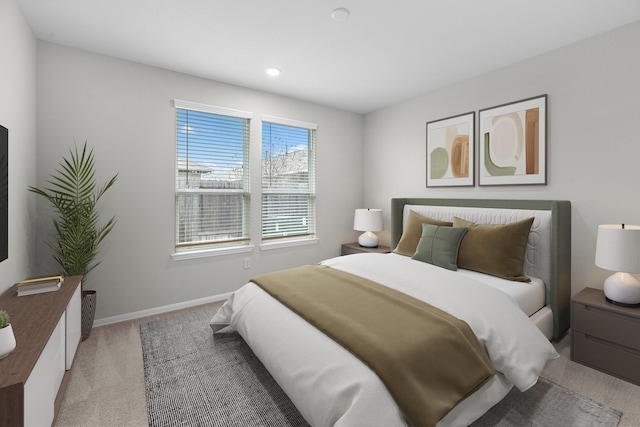 bedroom featuring light carpet and baseboards