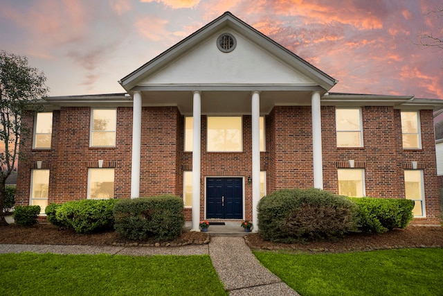 greek revival house featuring brick siding