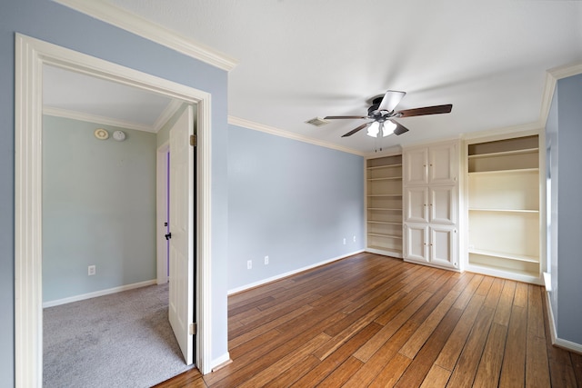 unfurnished bedroom featuring ornamental molding, wood-type flooring, visible vents, and baseboards