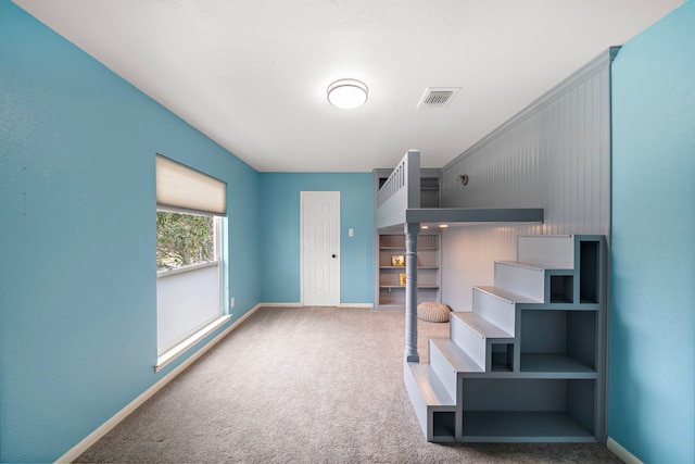 stairs featuring baseboards and carpet flooring