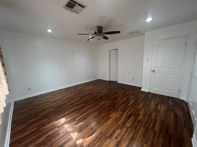 unfurnished bedroom with dark wood finished floors, a closet, visible vents, a ceiling fan, and baseboards