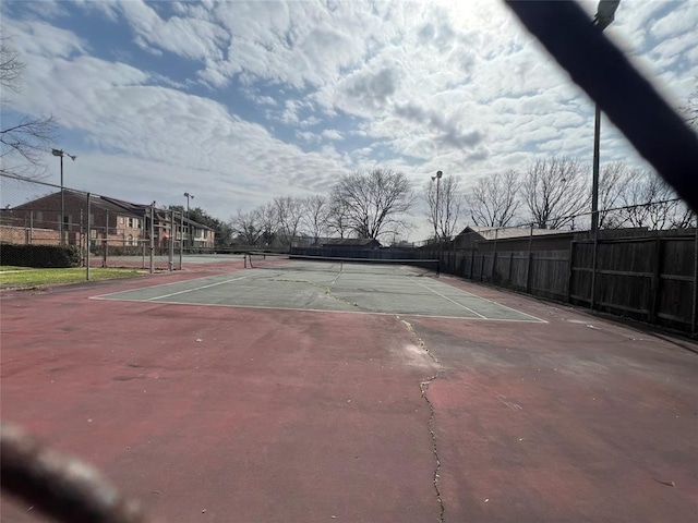 view of sport court with fence