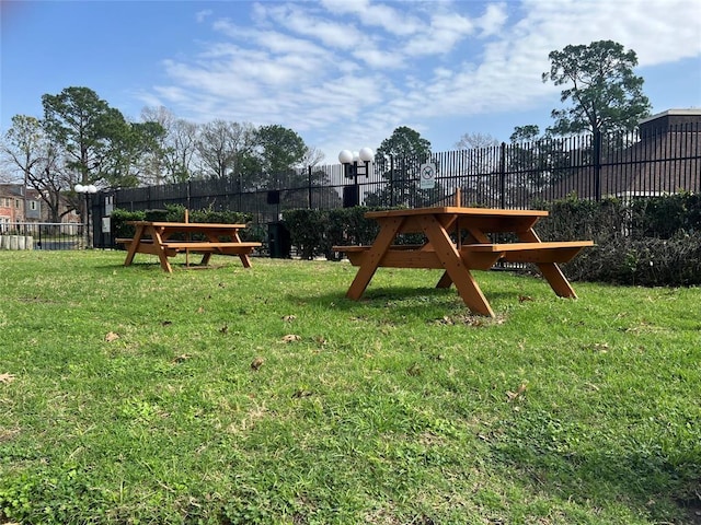 view of jungle gym with fence and a lawn