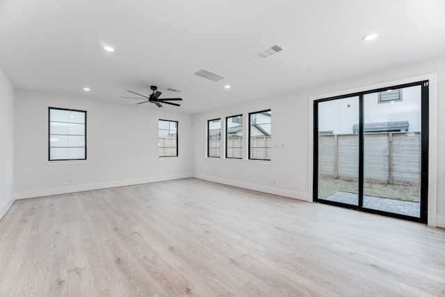 empty room with recessed lighting, light wood-type flooring, visible vents, and baseboards