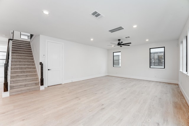 empty room with stairs, recessed lighting, visible vents, and light wood-style floors