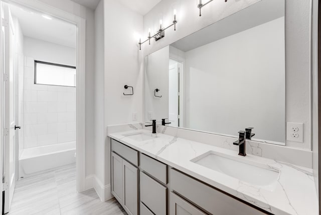 bathroom with shower / washtub combination, a sink, and double vanity