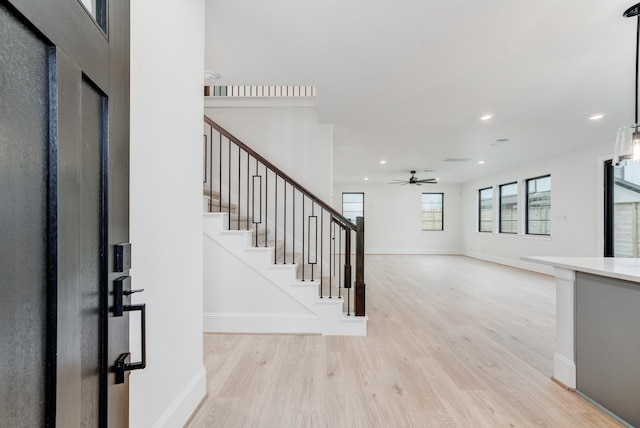 foyer featuring light wood finished floors, recessed lighting, ceiling fan, baseboards, and stairs