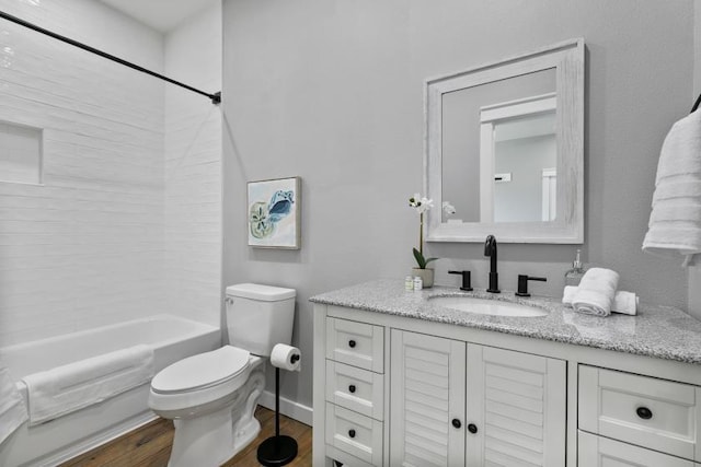 bathroom with toilet, bathtub / shower combination, wood finished floors, and vanity