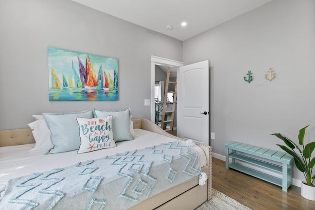 bedroom with recessed lighting, wood finished floors, and baseboards