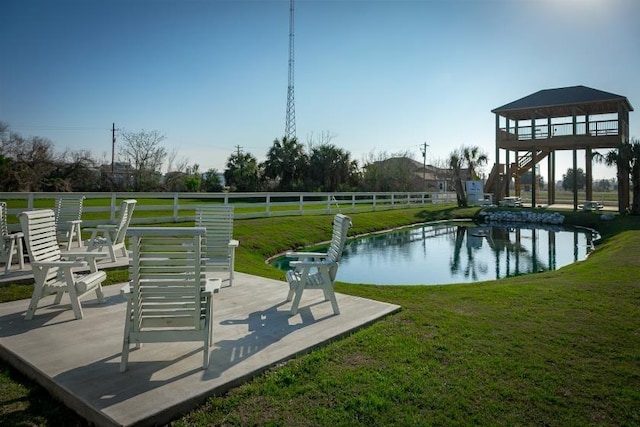 view of home's community featuring a yard and fence