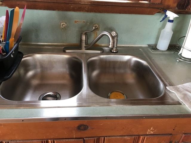 interior details featuring brown cabinetry and a sink