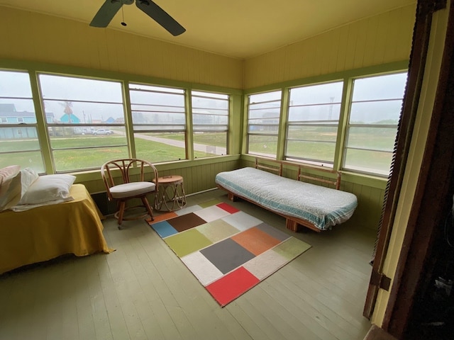 sunroom featuring ceiling fan