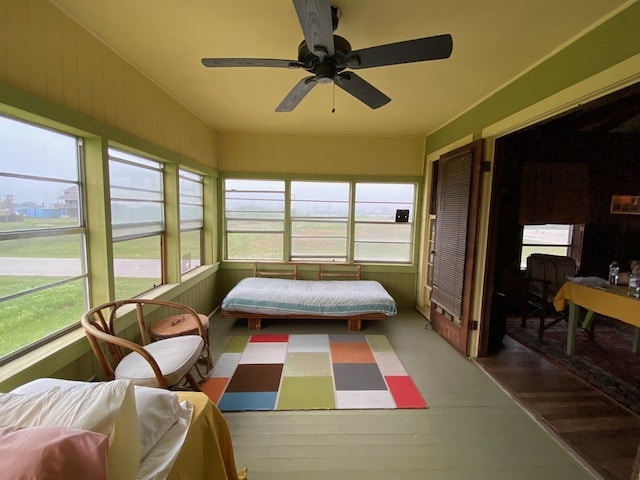 sunroom with a ceiling fan and a wealth of natural light