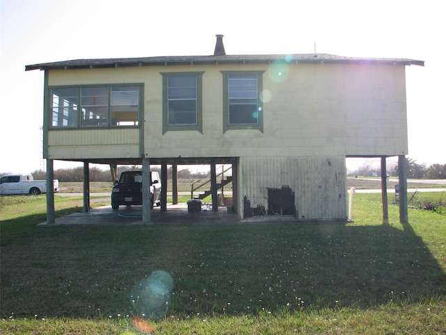 back of property featuring a yard and stairs