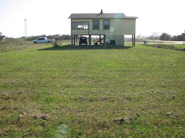 rear view of house with a lawn