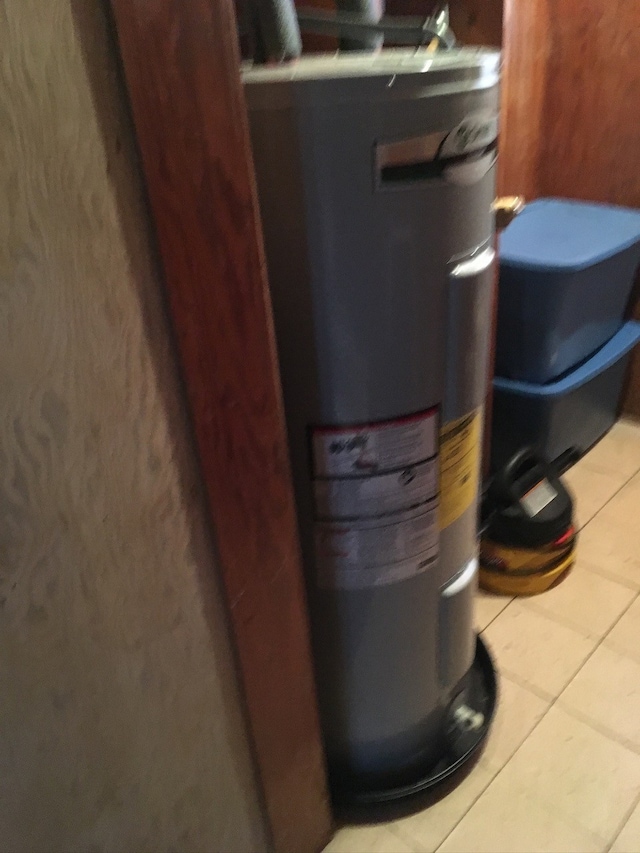 utility room with electric water heater