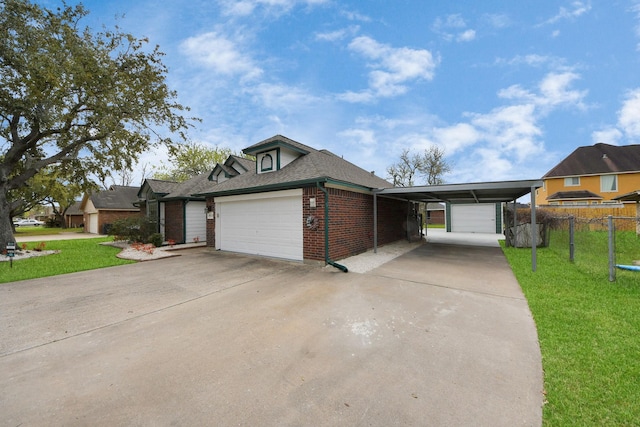 view of front facade with driveway, brick siding, a front yard, and fence