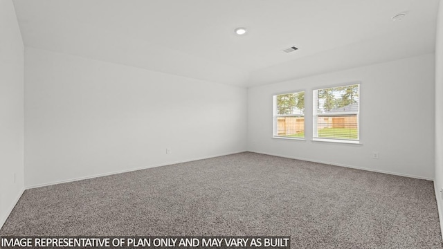 carpeted spare room with visible vents and baseboards