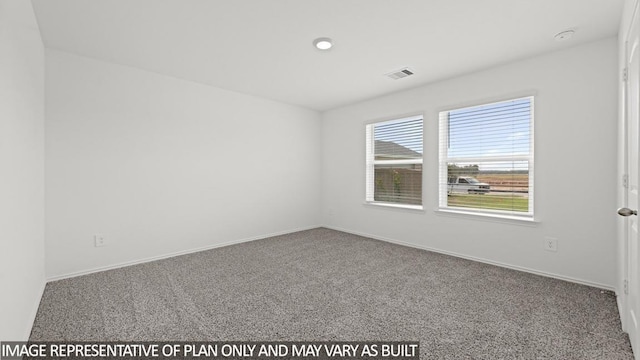 empty room featuring carpet, visible vents, and baseboards