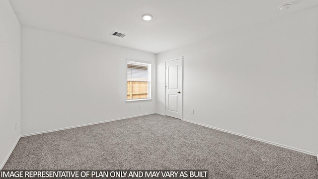 carpeted spare room featuring visible vents and baseboards