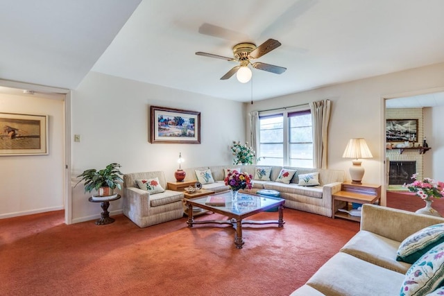 carpeted living area with a brick fireplace, a ceiling fan, and baseboards