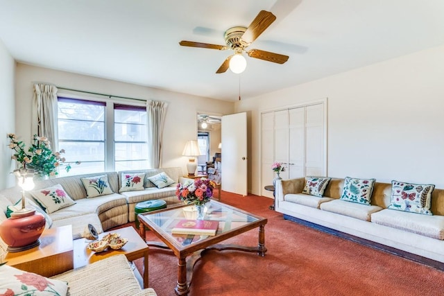 living room with a ceiling fan and carpet flooring