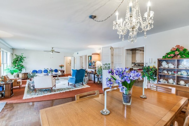 dining area with ceiling fan with notable chandelier