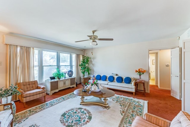 carpeted living area with ceiling fan