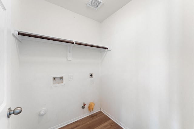 laundry room featuring gas dryer hookup, hookup for a washing machine, laundry area, wood finished floors, and visible vents