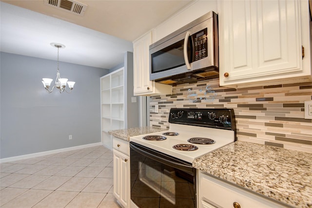 kitchen with electric range, baseboards, visible vents, stainless steel microwave, and backsplash