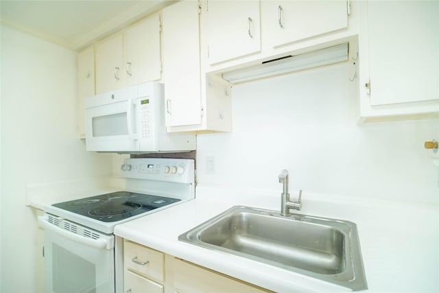 kitchen with white cabinets, white appliances, light countertops, and a sink