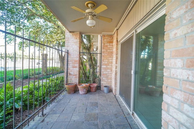 view of patio / terrace featuring ceiling fan and fence