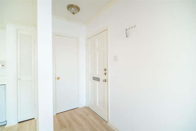 hall featuring light wood-style floors and crown molding