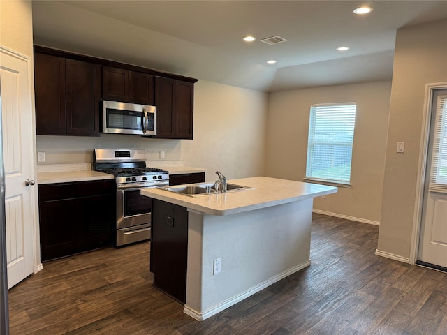 kitchen with stainless steel appliances, light countertops, visible vents, and a sink