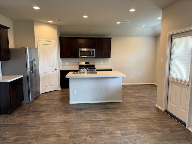 kitchen featuring dark wood-type flooring, stainless steel appliances, light countertops, and recessed lighting