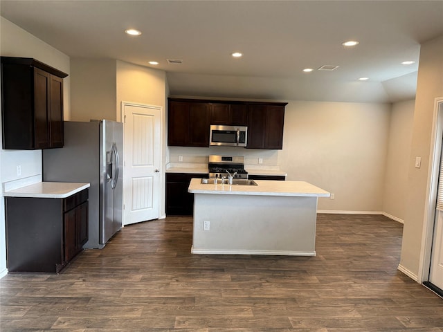 kitchen with light countertops, appliances with stainless steel finishes, dark wood-type flooring, and visible vents